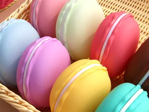 Detailed macro shot of colorful macaron-shaped jewelry storage boxes in a wicker basket