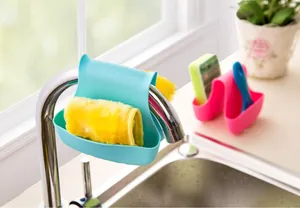 Saddle-style sink sponge holder hanging on faucet for efficient kitchen drainage