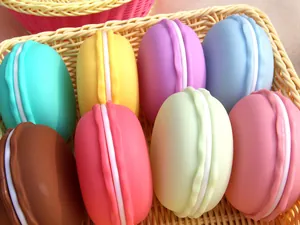 Macro view of colorful macaron-shaped jewelry storage boxes in a woven basket