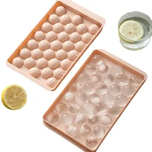 Pink round ice cube tray mold with lid for making spherical ice balls