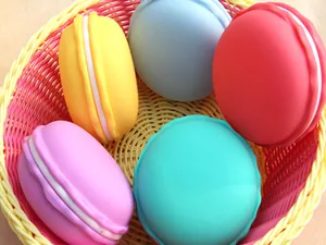 Close-up of colorful macaron-shaped jewelry storage boxes arranged in a woven basket