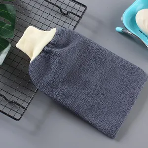 Detailed view of grey exfoliating bath glove showing thick textured fabric and band