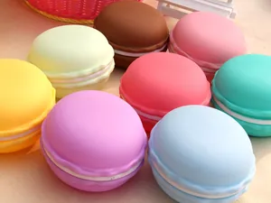 Macro view of colorful macaron-shaped jewelry storage boxes in pastel tones.