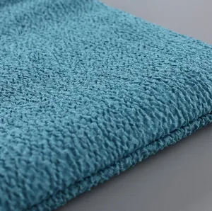 Close-up macro detail of blue honeycomb textured exfoliating bath towel fabric surface