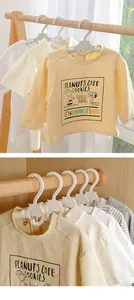 Detailed close-up of non-slip adjustable plastic hangers for baby and kids clothing