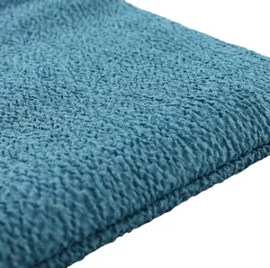 Macro view of teal blue textured exfoliating bath scrub towel for deep skin cleaning