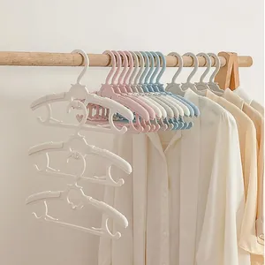 High-quality multi-color non-marking children's clothes hangers organized on a wooden rod