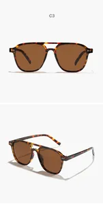Klassieke aviator zonnebril met schildpadmontuur, bruine glazen en dubbele brug detail.
