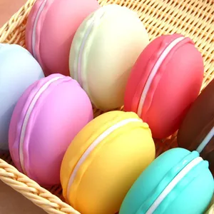Assorted colorful macaron shaped plastic jewelry storage boxes in a woven basket