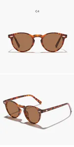 Detailed front and side views of tortoise shell round sunglasses with brown lenses