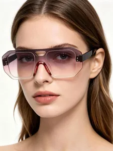 Detailed view of oversized gradient lens frameless aviator shield sunglasses on model