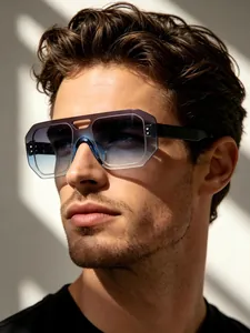 Close-up detail of frameless aviator sunglasses with gradient blue lenses on male model