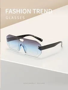 Close-up of rimless pilot sunglasses with blue gradient lenses and black temples