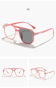 Detail view of children's pink aviator photochromic glasses showing lens tint change
