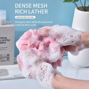 Large soft pink bath ball mesh sponge creating rich dense foam for gentle skin exfoliation