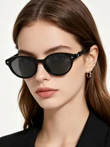 Professional close-up of stylish black cat-eye sunglasses worn by a female model