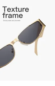 Detail view of the polished gold metal frame and dark lenses of these hip hop sunglasses