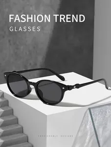Detailed view of minimalist black cat-eye sunglasses with silver diamond accents