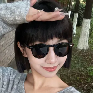 Stylish round frame sunglasses for UV protection worn by a model in an outdoor setting