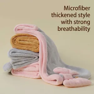 Stack of thickened absorbent microfiber hair drying caps with bowknots for women