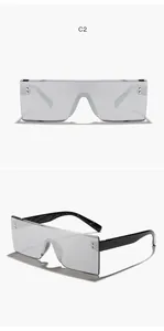 Vista detallada de gafas de sol rectangulares sin montura grises con diseño de parte superior plana