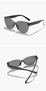 Close-up of rimless cat-eye sunglasses featuring silver rivet accents and black temples