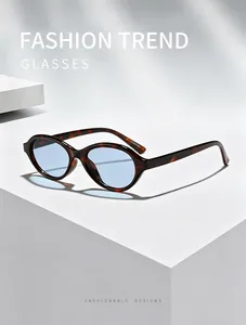 Vintage oval tortoiseshell sunglasses with light blue lenses on minimalist white steps