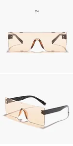 Vista detallada de gafas de sol retro sin montura con lentes naranjas y patillas negras