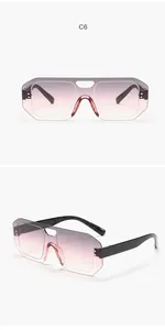 Close-up of frameless aviator sunglasses with gradient purple pink one-piece lens.