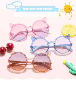 Detail of jelly-colored round kids sunglasses with cute cat ears and glitter finish