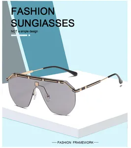 Detail view of oversized integrated lens sunglasses with decorative gold top bar