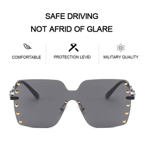 Front view detail of oversized rimless sunglasses with gold rivet accents