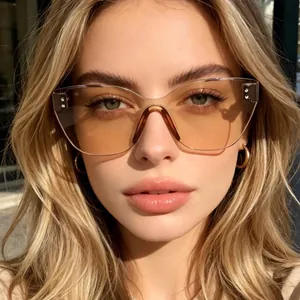 Stylish rimless irregular cat-eye sunglasses with orange tinted lenses and stud details