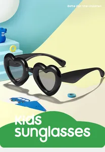 Detailed view of stylish black heart-shaped kids sunglasses on a colorful background