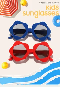 Close-up detail of stylish blue and red flower-shaped kids sunglasses on beach background.