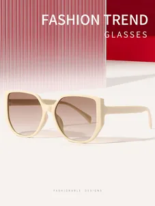 Detailed close-up of beige square fashion sunglasses featuring gradient brown lenses