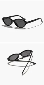 Professional detail view of black vintage oval sunglasses with sleek glossy frames.