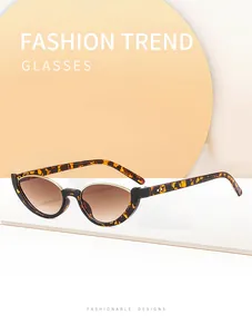 Close-up of tortoise shell cat-eye semi-rimless sunglasses with brown gradient lenses.
