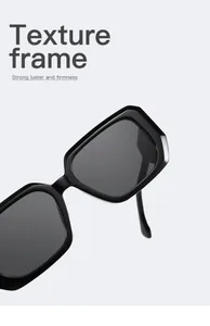 Macro shot of black wide-frame square sunglasses highlighting glossy texture finish