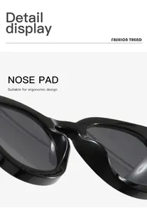 Detailed macro view showing the ergonomic nose pad of retro black oval sunglasses.