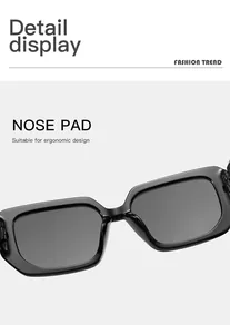 Detailed macro view of ergonomic nose pads on stylish black rectangular sunglasses.