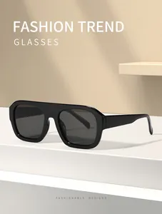 Close-up of black oversized aviator sunglasses with flat top bar design
