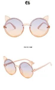 Detail of round kids' cat-ear sunglasses with glitter frame and gradient lenses.
