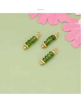 Vista detallada de colgantes de piedra natural facetada verde con lazos dorados para DIY