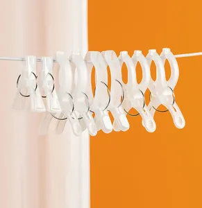 Detail view of transparent frosted plastic windproof clips in various sizes on a wire line