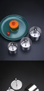 Detail view of professional stainless steel round food mold set with press plate.