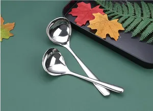 Detailed macro view of polished stainless steel soup ladles with thickened large heads