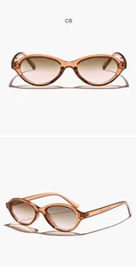 Close-up of retro oval sunglasses with amber transparent frame and gradient lenses