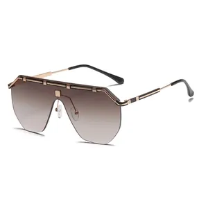 Oversized one-piece gradient lens sunglasses with vintage gold metal accents