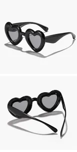 Detailed view of retro black heart-shaped sunglasses for kids showing frame and lenses.